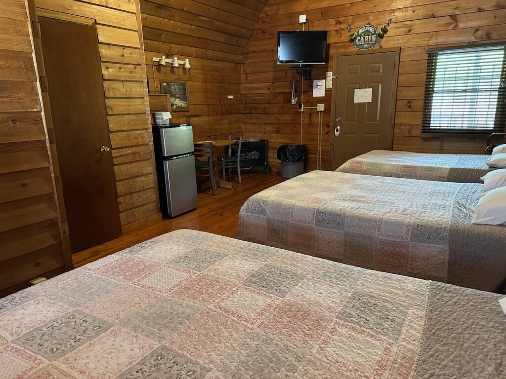 Poolside Cabin 23 with 3 double beds, the breakfast nook and the TV