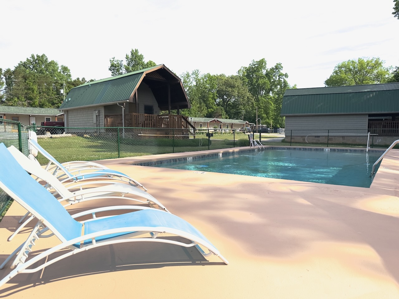 lounge chairs at the pool with cabin 21 and 22 in the background