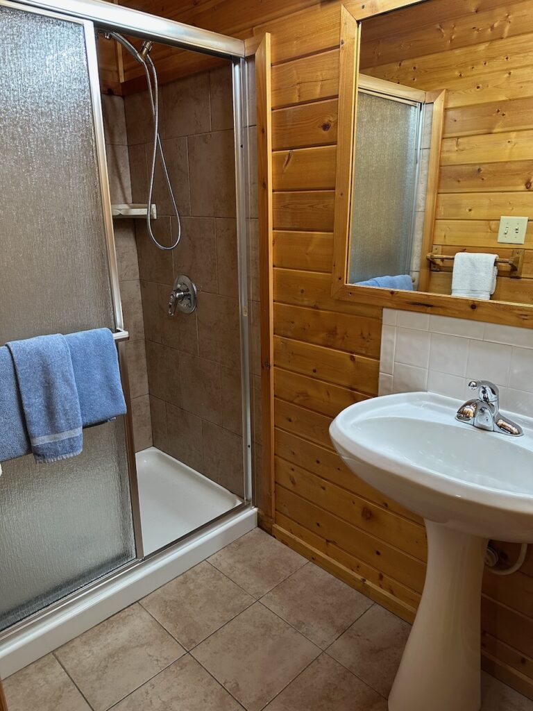 half bath showing shower and vanity in Heritage Cabin