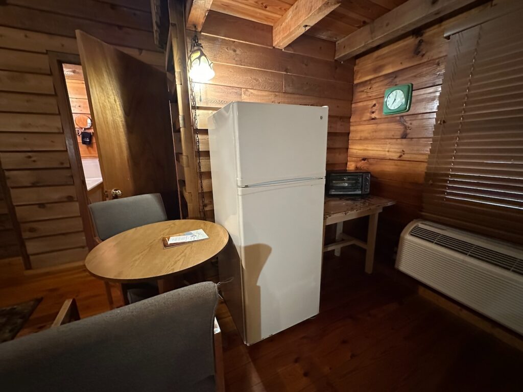 cabin 20 eating area with small table and chairs and refridgerator