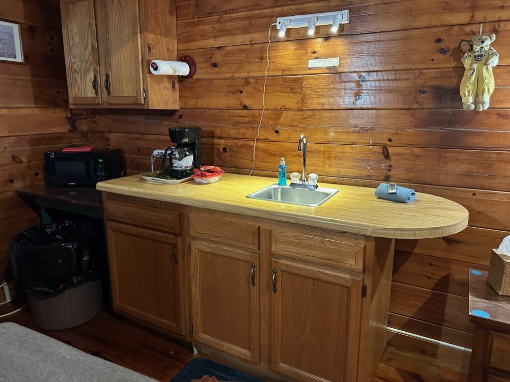 cabin 20 efficiency area with counter top, microwave, refrigerator, and coffee maker