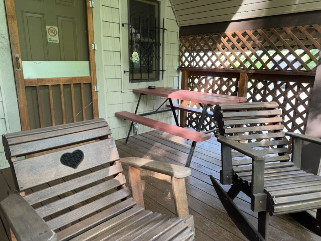 porch of Riverside Cabin with 2 rocking chairs and a picnic table