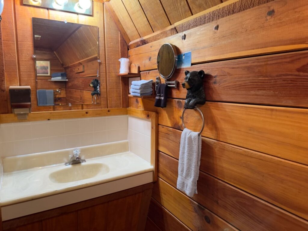 vanity in bathroom of riverside cabins showing hairdryer and hand towels