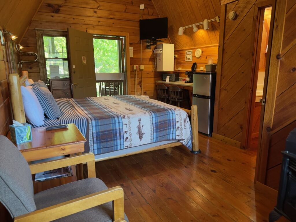 inside of riverside cabins at docks motel showing king bed and efficiency kitchen