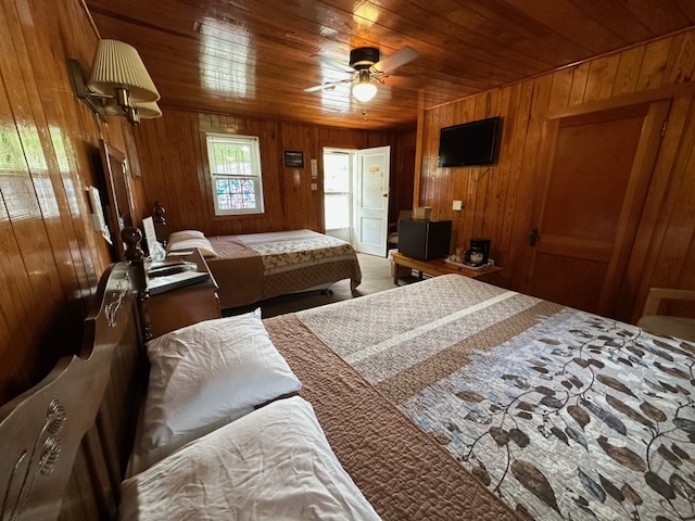 Motel room with 2 queen beds taken from an angle that shows the door